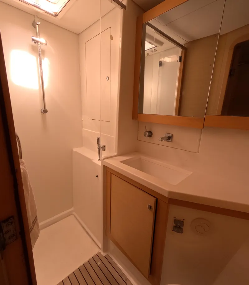 Slide: The Image of Compact bathroom in a 2014 Lagoon 450 yacht, featuring a shower and sink. - 32