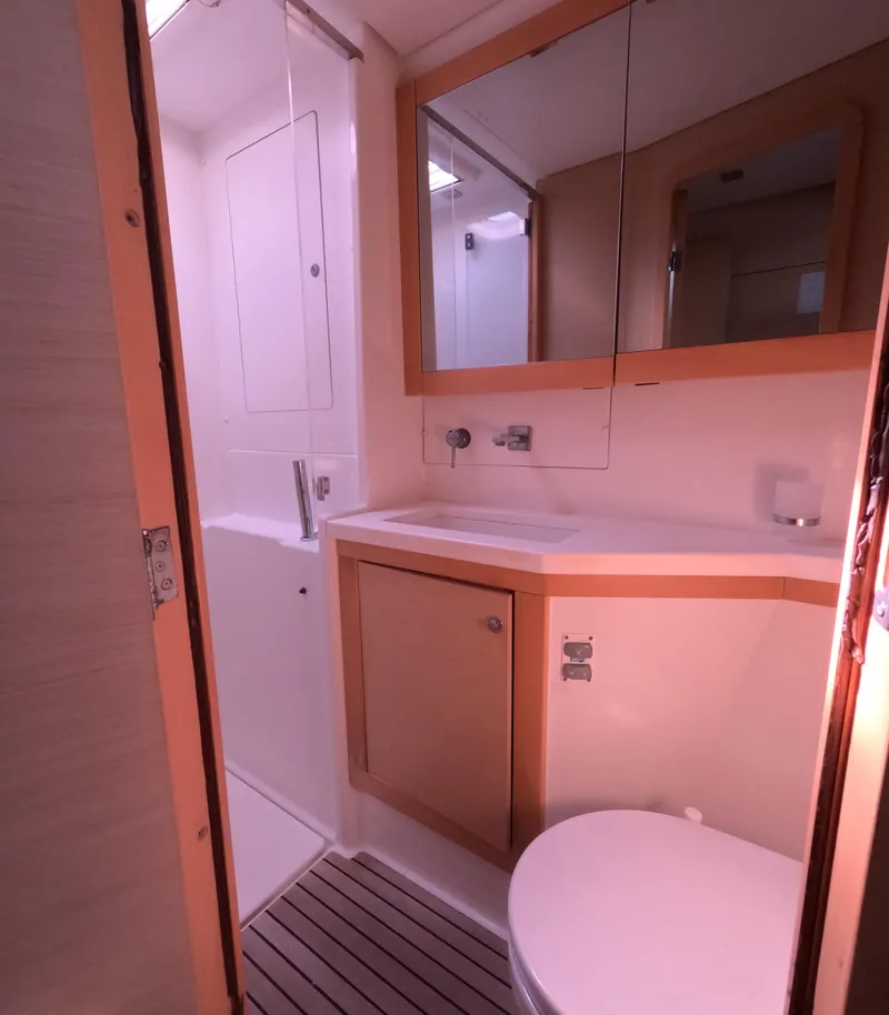 Slide: The Image of 2014 Lagoon 450 yacht bathroom with modern fixtures and wooden accents. - 38