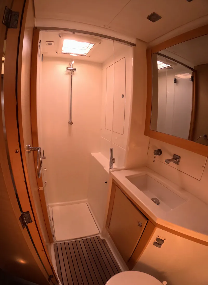 Slide: The Image of 2014 Lagoon 450 yacht bathroom with shower, sink, and mirror. - 39
