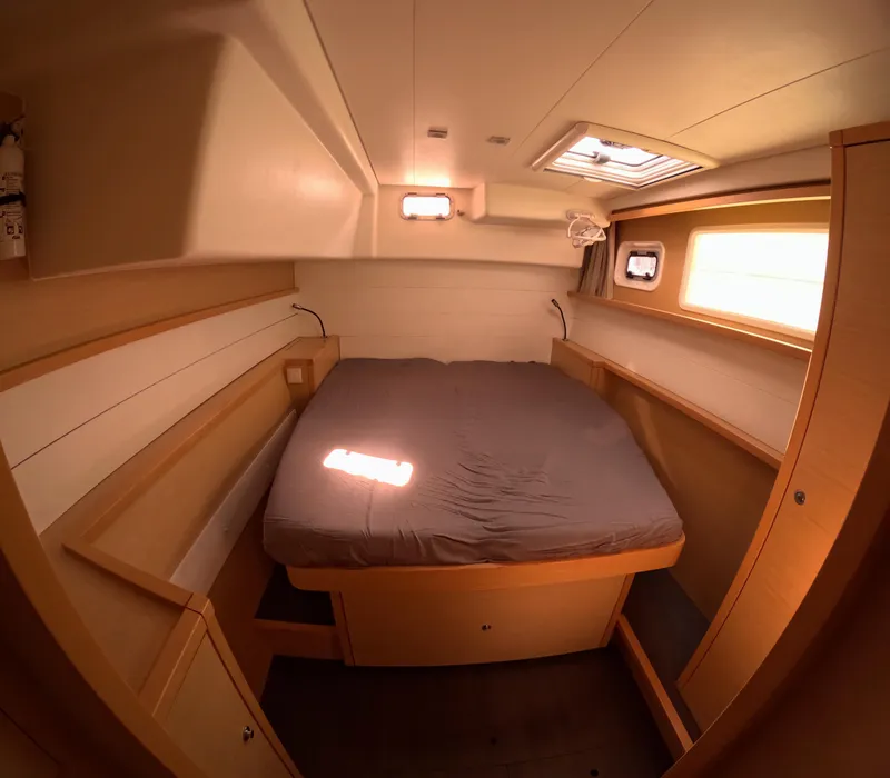 Slide: The Image of Cozy cabin interior of 2014 Lagoon 450 catamaran with bed and wooden furnishings. - 40