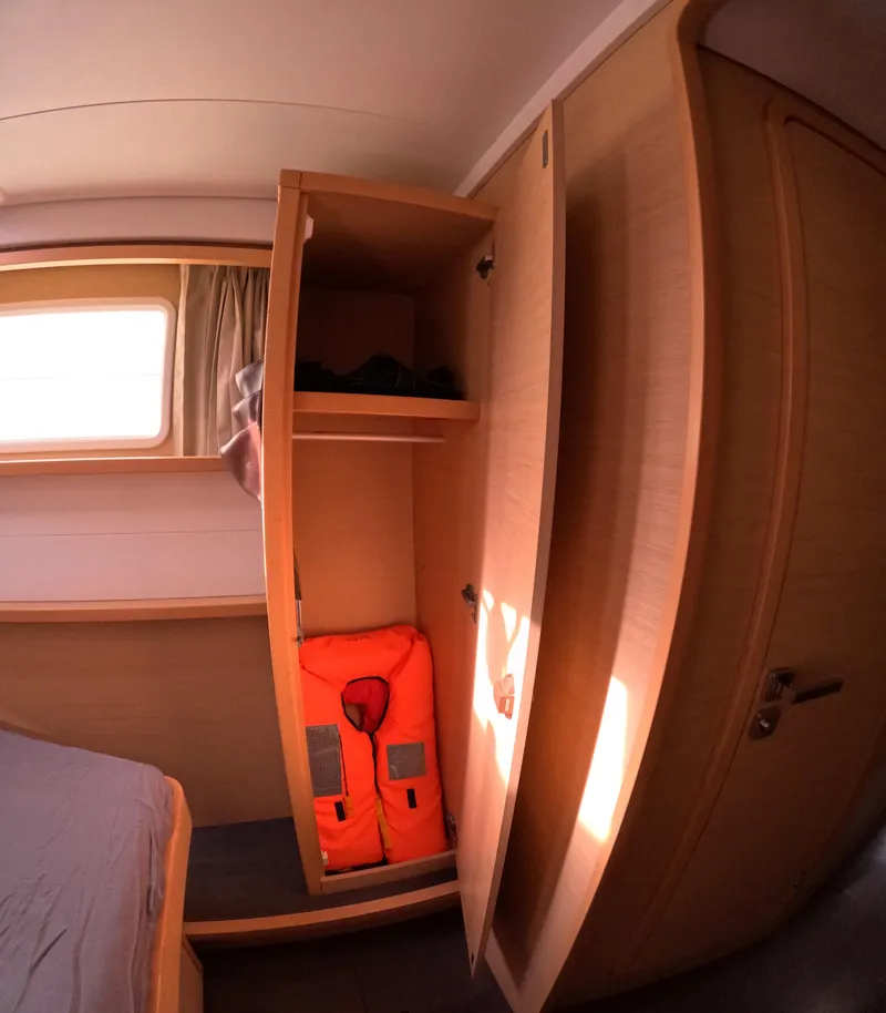 Slide: The Image of Interior of 2014 Lagoon 450 yacht cabin with open closet and life jacket. - 41