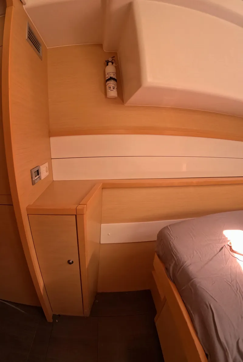 Slide: The Image of Interior cabin of 2014 Lagoon 450 yacht with wooden furnishings and bed. - 42