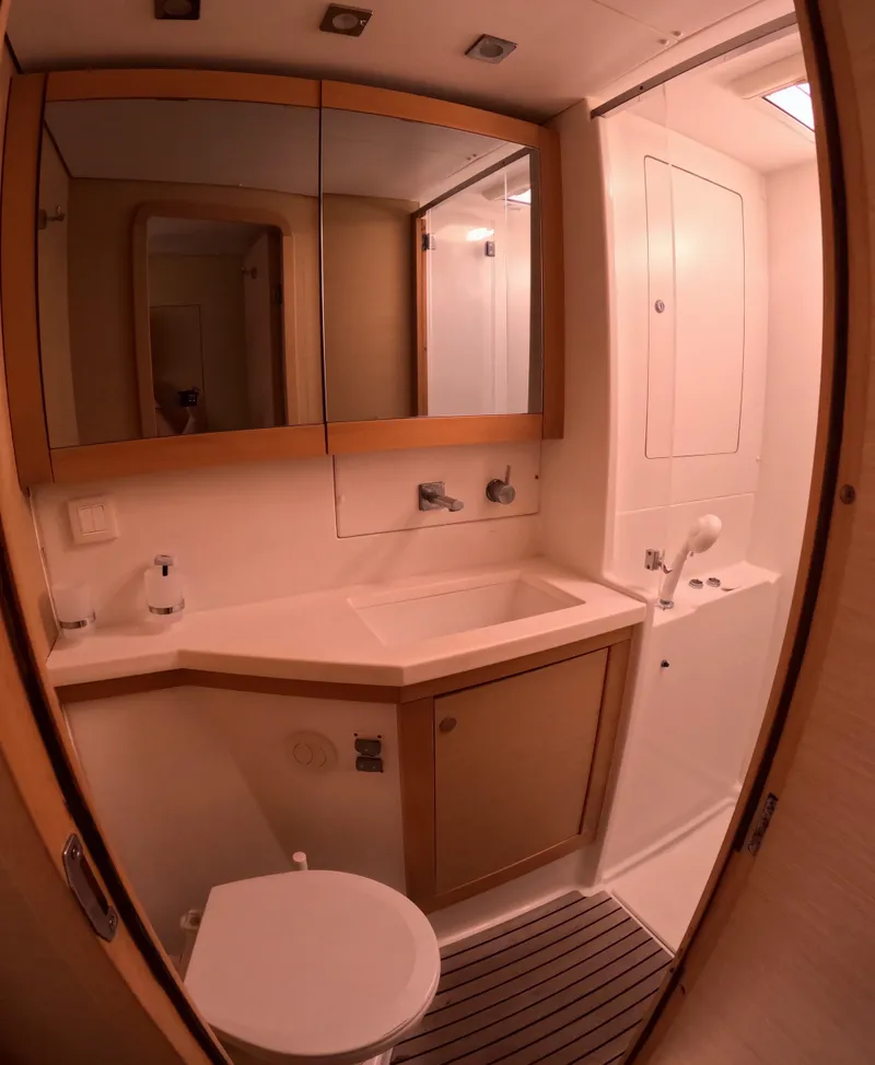 Slide: The Image of 2014 Lagoon 450 yacht bathroom with modern fixtures and mirrored cabinets. - 44