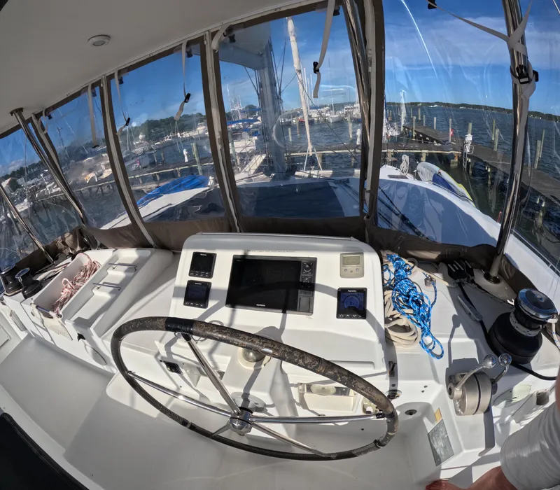 Slide: The Image of Helm of 2014 Lagoon 450 catamaran with steering wheel and navigation equipment. - 8