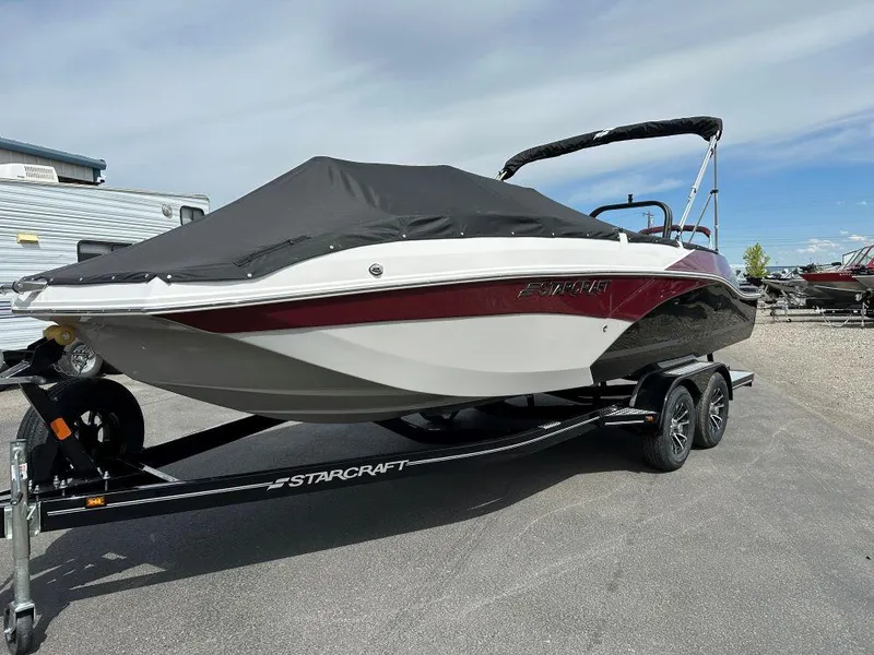 The Image of 2024 Starcraft SVX 211 OB boat on trailer with cover, side view. - 0
