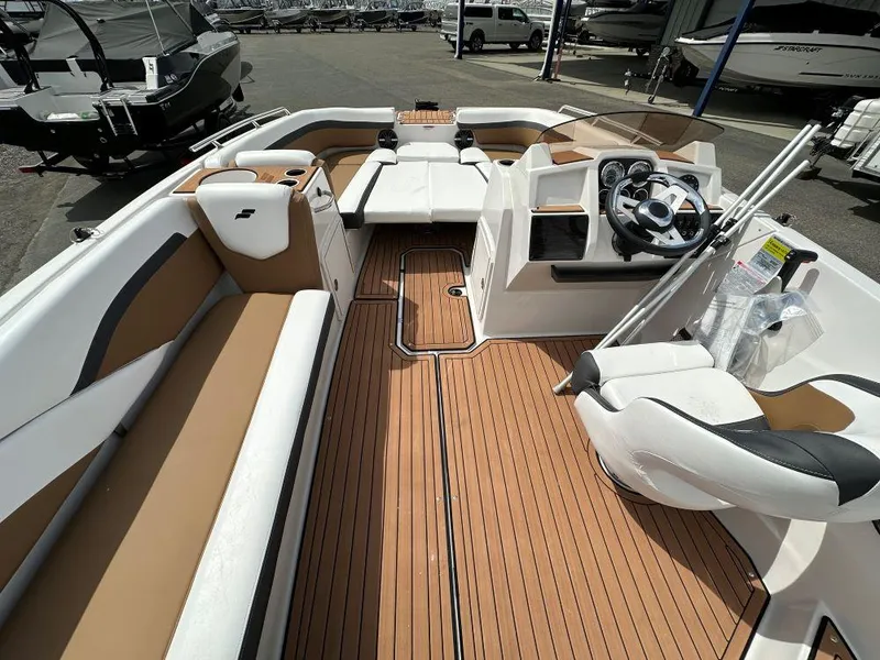 Slide: The Image of 2024 Starcraft SVX 211 OB boat interior with tan and white seating. - 6