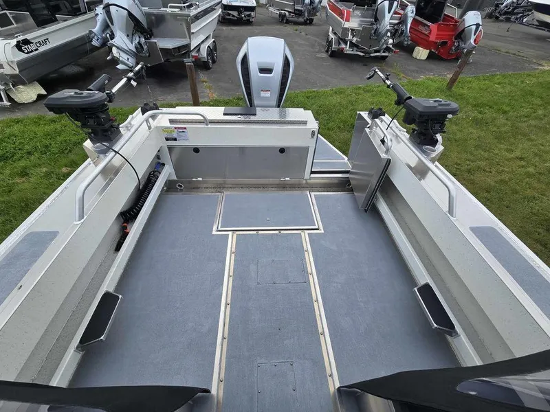 Slide: The Image of 2024 Silver Streak RENFREW boat interior with fishing rod holders and motor. - 2