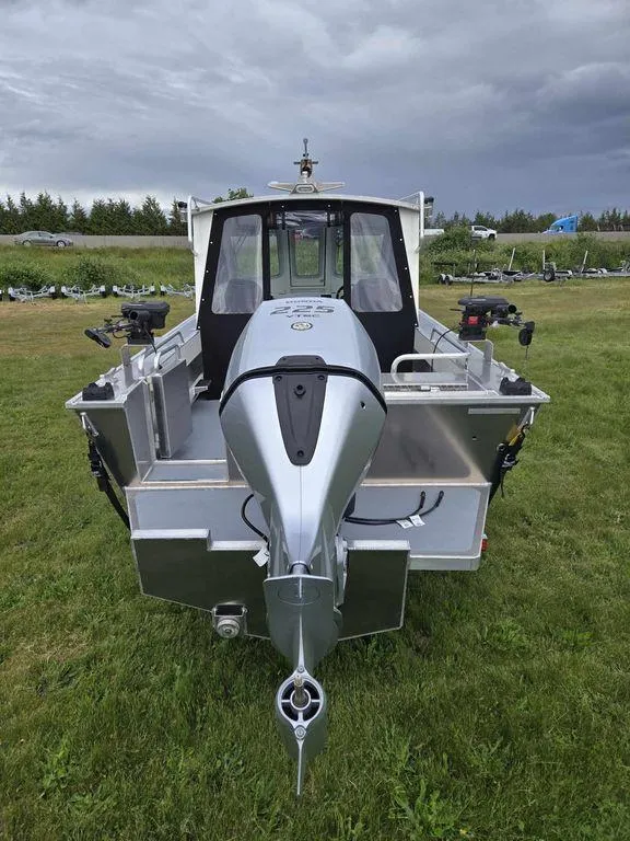Slide: The Image of 2024 Silver Streak RENFREW boat with outboard motor on grassy field. - 4