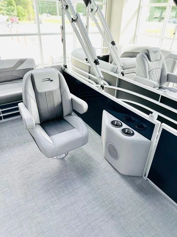 Slide: The Image of 2025 Bennington 24 SXSB boat interior with luxurious seating and cup holders. - 10