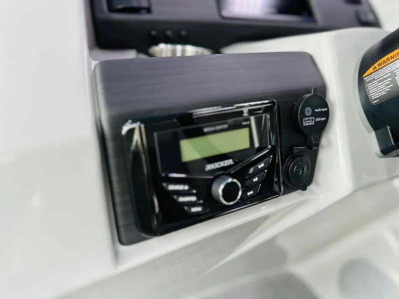 Slide: The Image of Close-up of the 2025 Bennington 24 SXSB boat's control panel and radio system. - 11