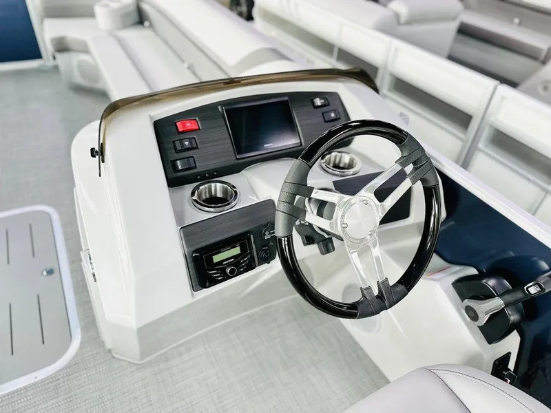 Slide: The Image of 2025 Bennington 24 SXSB boat dashboard with steering wheel and control panel. - 2