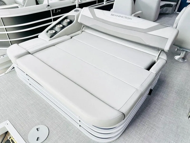 Slide: The Image of 2025 Bennington 24 SXSB boat with luxurious seating and cup holders. - 6