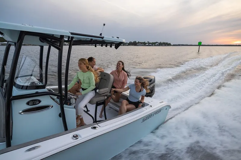 Slide: The Image of 2024 Sea Pro 222 Center Console boat with passengers enjoying a ride at sunset. - 13