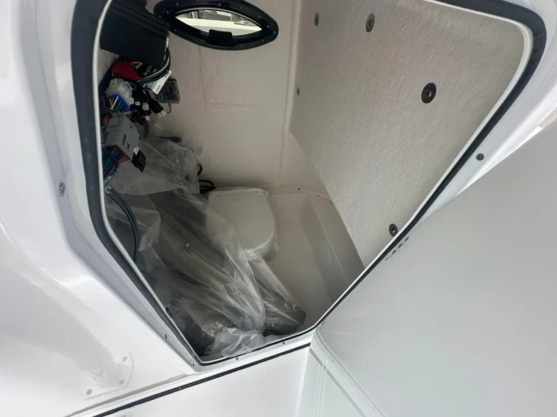 Slide: The Image of 2024 Sea Pro 222 Center Console interior storage compartment with wiring and equipment. - 7