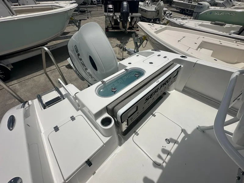 Slide: The Image of 2024 Sea Pro 222 Center Console boat with Suzuki outboard motor, docked at a marina. - 9