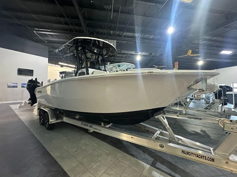 The Image of 2024 Sea Pro 242 Center Console boat on trailer in showroom. - 1