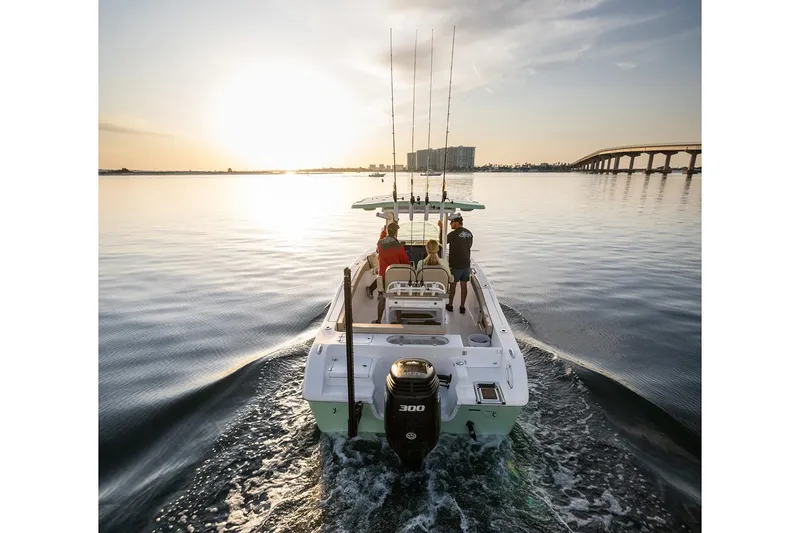 Slide: The Image of 2024 Sea Pro 242 Center Console boat cruising at sunset with fishing rods. - 18