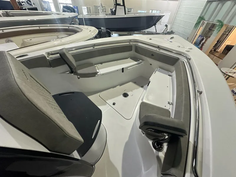 Slide: The Image of 2024 Sea Pro 242 Center Console boat interior with seating and storage compartments. - 5