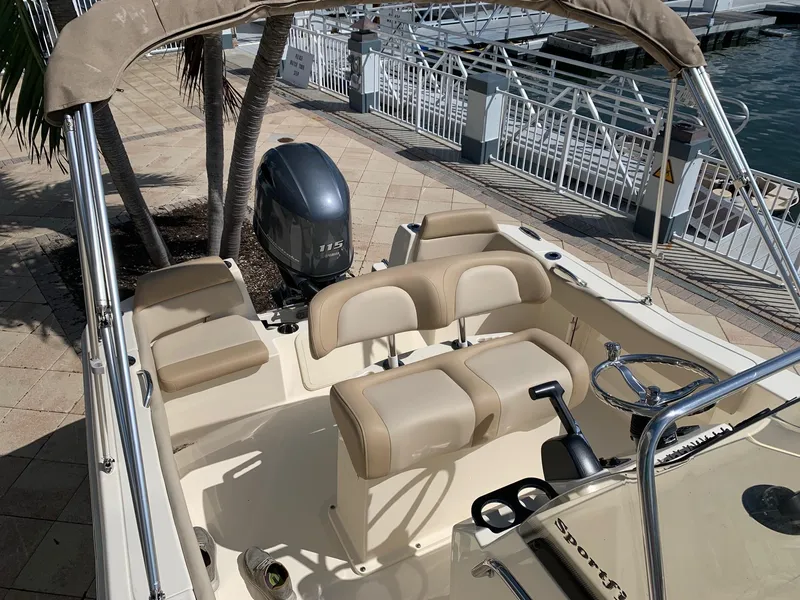 Slide: The Image of 2024 Scout 195 Sportfish boat interior with seating and outboard motor. - 3