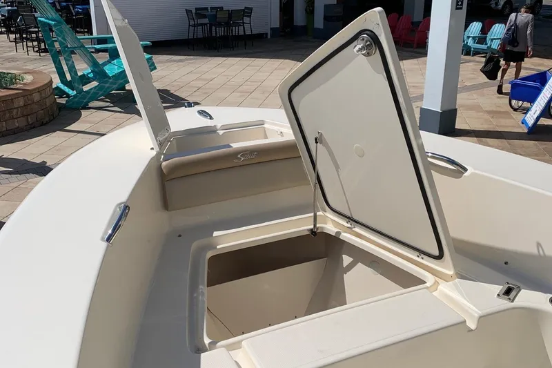 Slide: The Image of 2024 Scout 195 Sportfish boat with open storage compartments. - 7