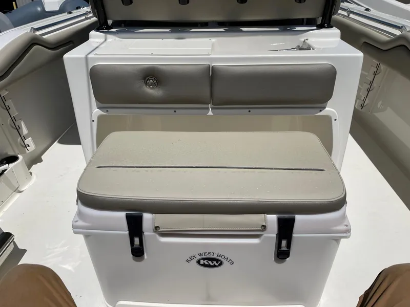Slide: The Image of 2022 Key West 263 FS boat interior with cushioned seating and storage. - 13
