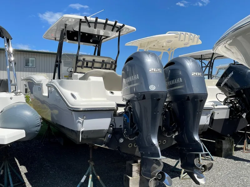 Slide: The Image of 2022 Key West 263 FS boat with dual Yamaha 200 engines, displayed outdoors. - 17