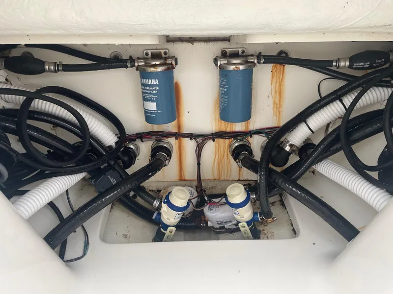 Slide: The Image of Key West 263 FS 2022 boat engine compartment with Yamaha filters and hoses. - 19