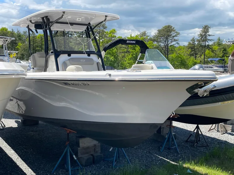 Slide: The Image of 2022 Key West 263 FS boat on display, surrounded by greenery and other boats. - 2