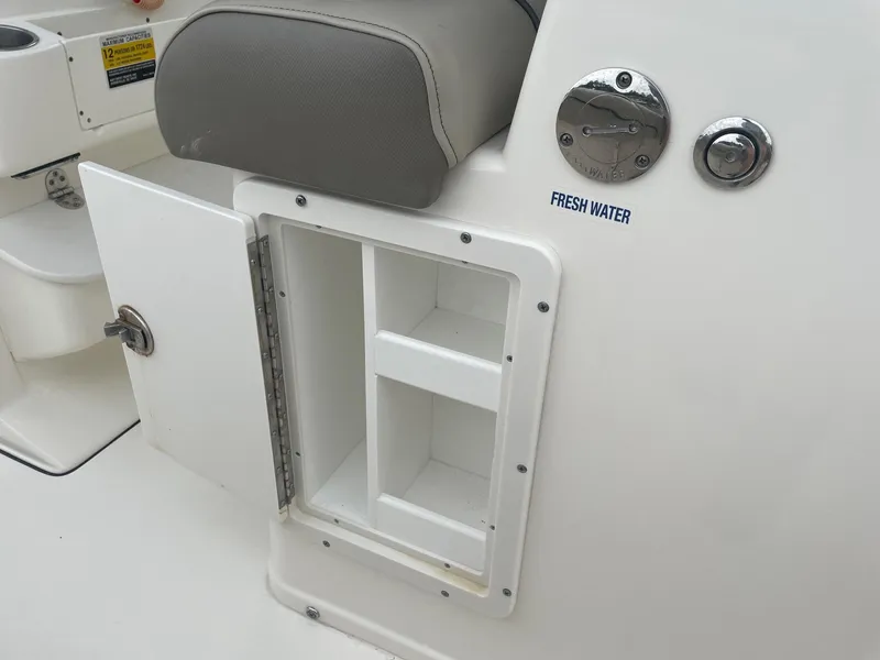 Slide: The Image of 2022 Key West 263 FS boat storage compartment with fresh water access. - 22