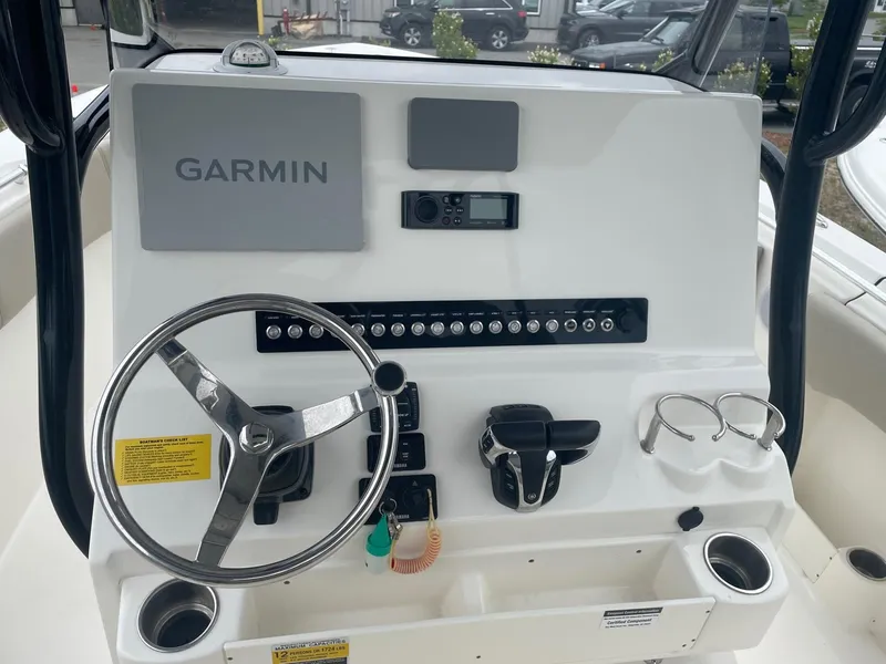 Slide: The Image of 2022 Key West 263 FS boat dashboard with Garmin navigation system and steering wheel. - 3
