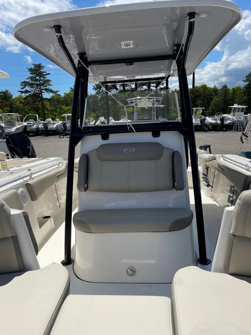 Slide: The Image of 2022 Key West 263 FS boat interior with seating and canopy, parked outdoors. - 9