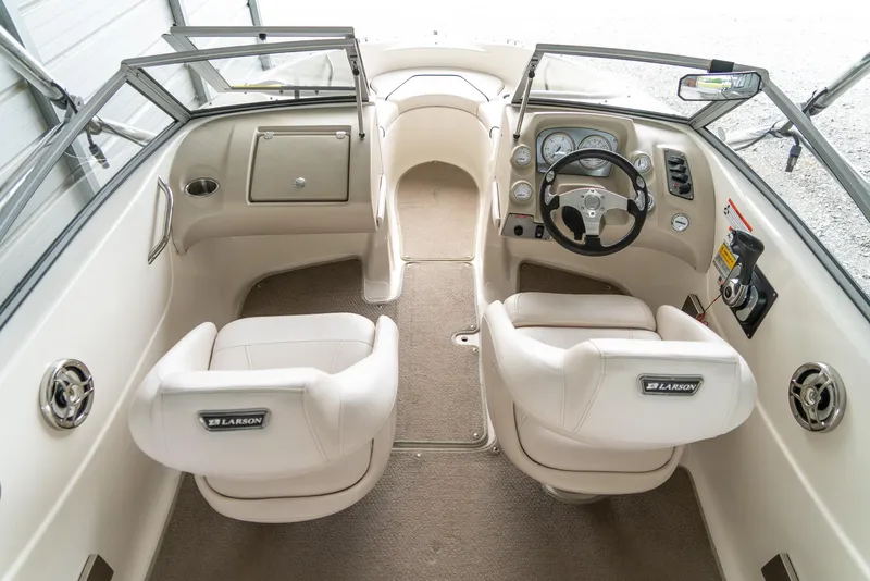 Slide: The Image of Interior of a 2010 Larson LX 1850 boat with beige seats and dashboard. - 11