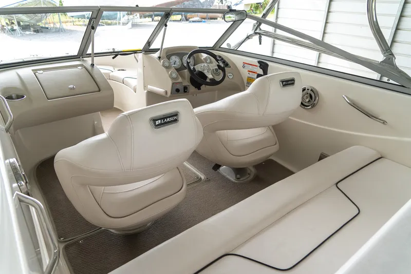 Slide: The Image of Interior of a 2010 Larson LX 1850 boat with beige seating and dashboard. - 16