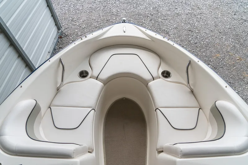 Slide: The Image of 2010 Larson LX 1850 boat interior with white cushioned seating. - 20