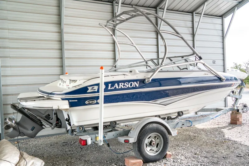 Slide: The Image of 2010 Larson LX 1850 boat on trailer in covered storage. - 4