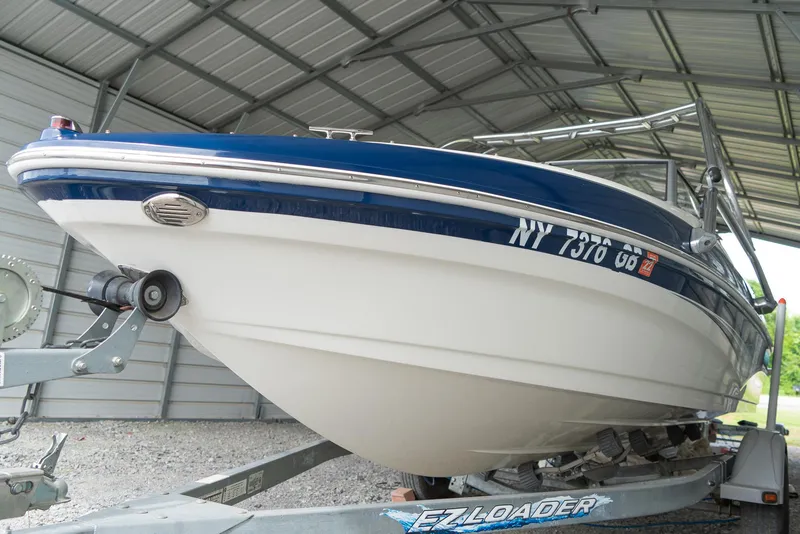 Slide: The Image of 2010 Larson LX 1850 boat on EZ Loader trailer in covered storage. - 6