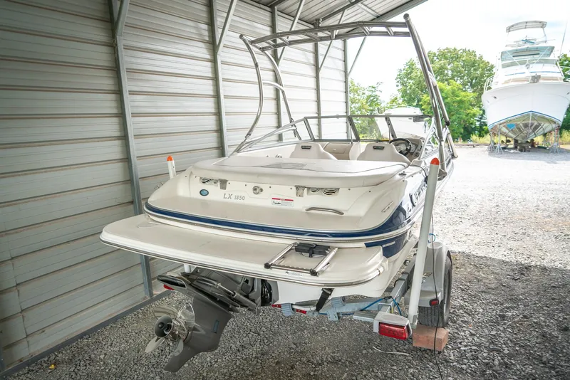 Slide: The Image of 2010 Larson LX 1850 boat in storage, rear view. - 8
