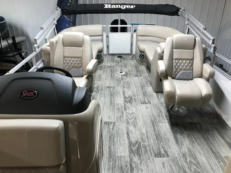 Slide: The Image of 2024 Ranger Reata 243C pontoon boat interior with luxurious seating and modern design. - 11