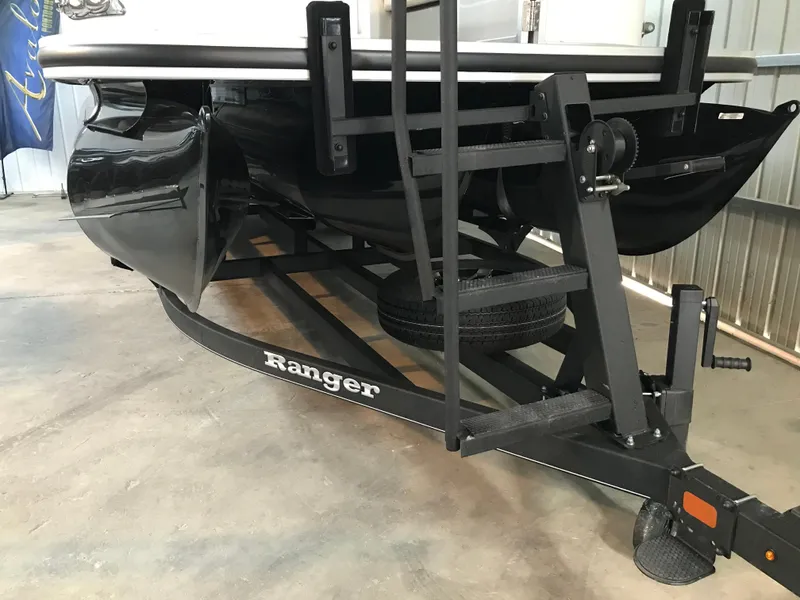 Slide: The Image of 2024 Ranger Reata 243C boat trailer in a garage setting. - 13