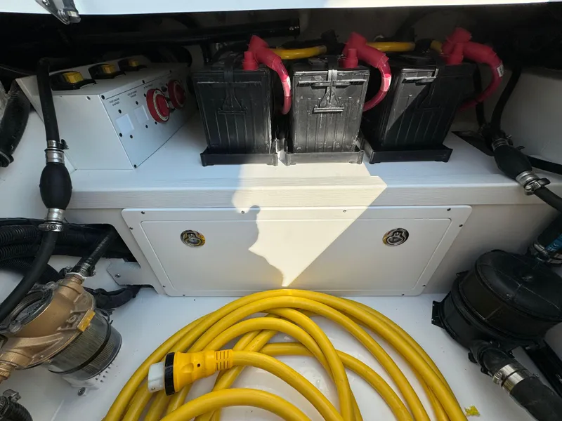Slide: The Image of Battery compartment of a 2025 Regulator 37 boat with yellow power cables. - 25