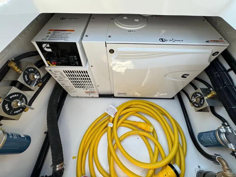 Slide: The Image of Engine compartment of 2025 Regulator 37 boat with generator and yellow power cables. - 26
