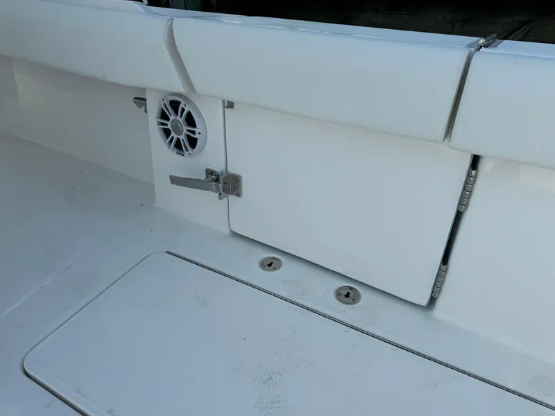 Slide: The Image of 2025 Regulator 37 boat interior with storage compartment and speaker. - 27