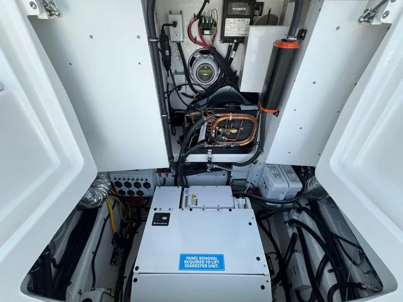 Slide: The Image of 2025 Regulator 37 boat engine compartment with electrical components and wiring. - 31