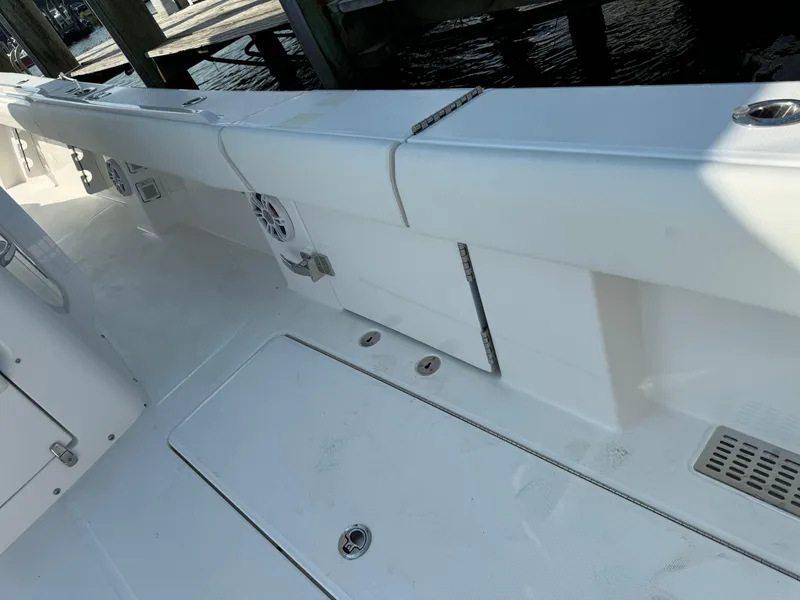 Slide: The Image of 2025 Regulator 37 boat deck with storage compartments and speaker. - 33