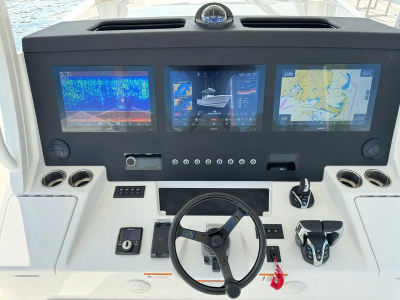 Slide: The Image of Control panel of a 2025 Regulator 37 boat with advanced navigation screens. - 35