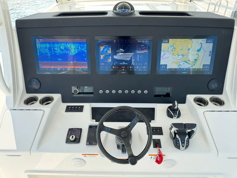 Slide: The Image of Control panel of a 2025 Regulator 37 boat with advanced navigation screens. - 36