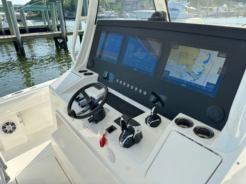 Slide: The Image of 2025 Regulator 37 boat helm with advanced navigation screens and controls. - 38