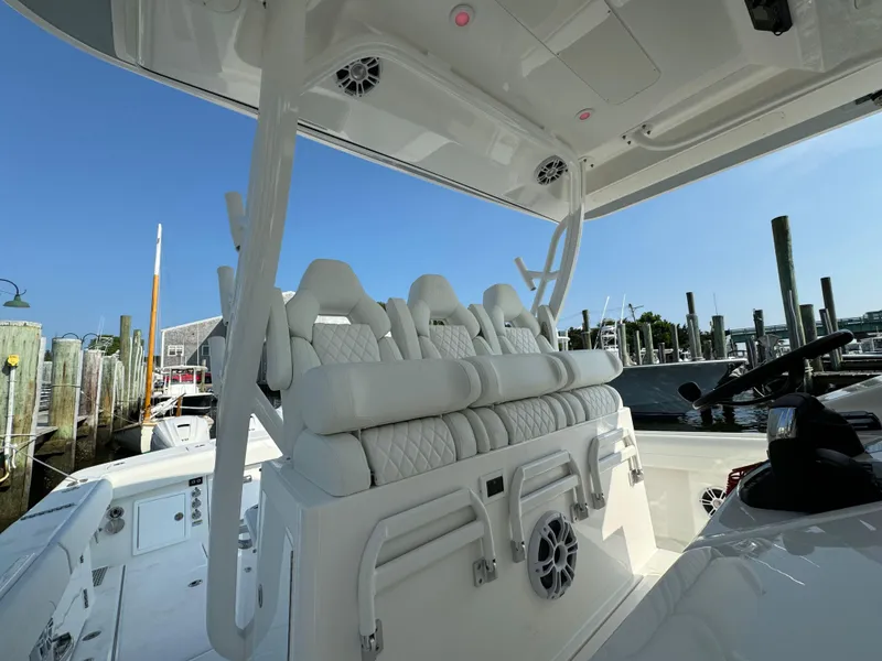 Slide: The Image of 2025 Regulator 37 boat interior with white seating and speakers. - 40