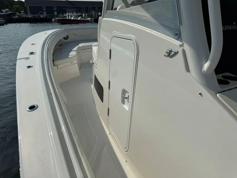 Slide: The Image of 2025 Regulator 37 boat, white exterior, docked at marina. - 43