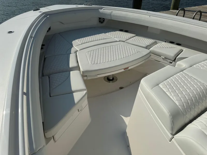 Slide: The Image of 2025 Regulator 37 boat with luxurious white seating and table. - 49